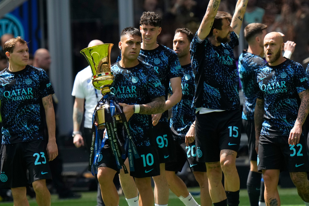 Inter Milan's Lautaro Martinez holds the trophy of the Italy's cup prior to the start of a Serie A soccer match between Inter Milan and Hellas Verona, in Milan, Italy, Sunday, May 17, 2026. (AP Photo