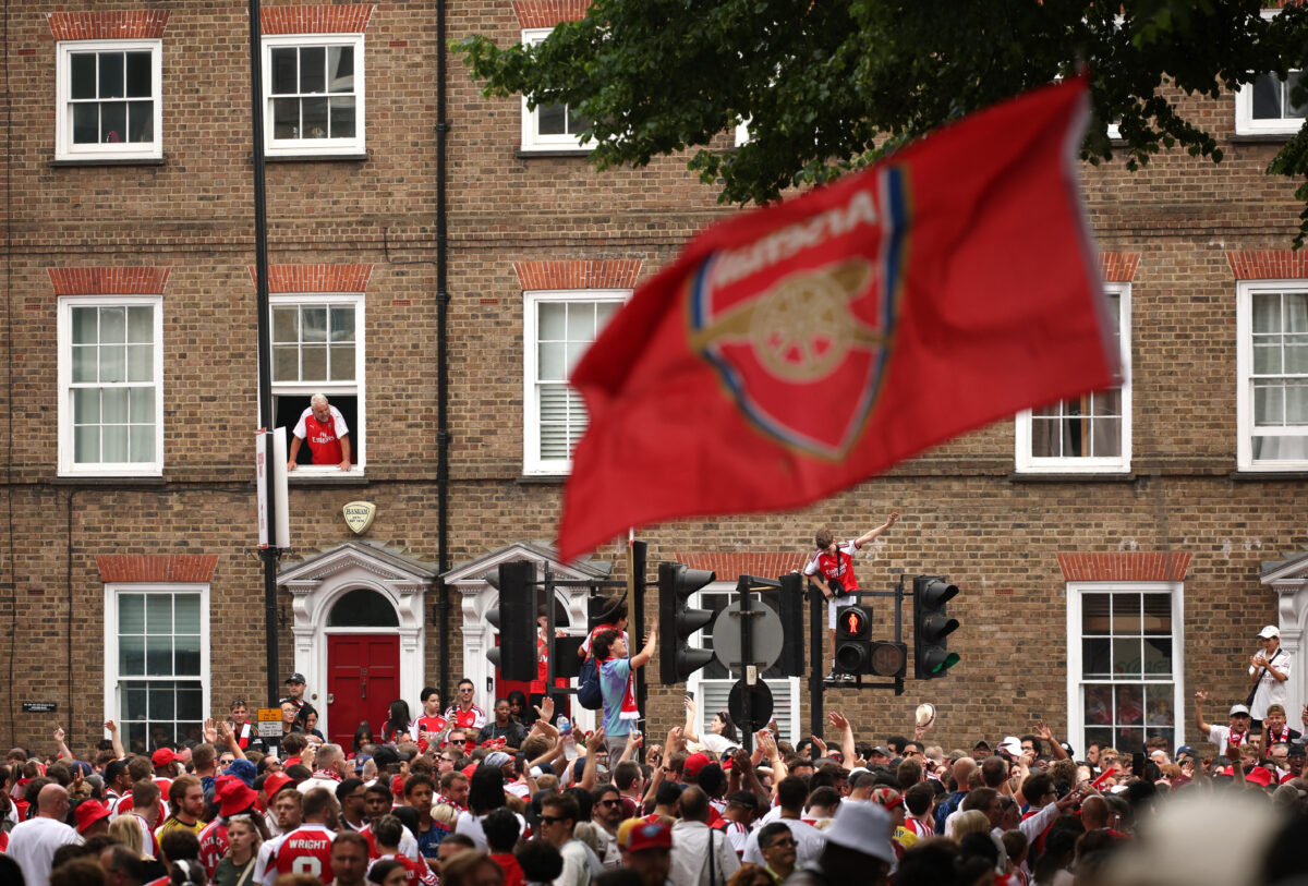 Soccer Football - Premier League - Arsenal Victory Parade - London, Britain - May 31, 2026 General view as an Arsenal fan stands on a traffic light as fans gather before the victory parade REUTERS