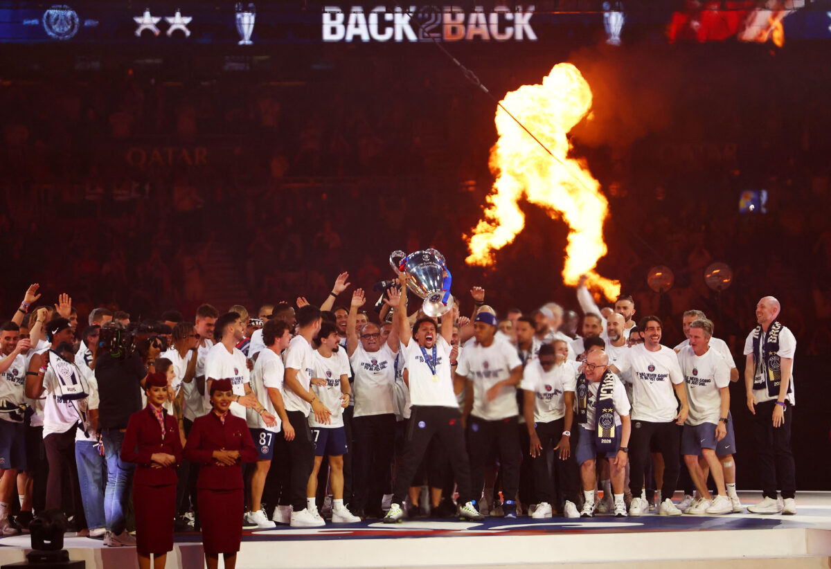 Soccer Football - UEFA Champions League - Paris St Germain celebrate winning the UEFA Champions League Final - Parc des Princes, Paris, France - May 31, 2026 Paris St Germain's Marquinhos lifts the trophy as he celebrates with teammates after winning the UEFA Champions League Final REUTERS