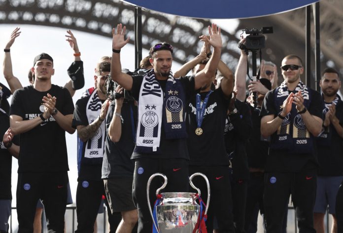 Soccer Football - UEFA Champions League - Paris St Germain celebrate winning the UEFA Champions League Final - Paris, France - May 31, 2026 Paris St Germain's Warren Zaire-Emery celebrates with the trophy after winning the UEFA Champions League REUTERS